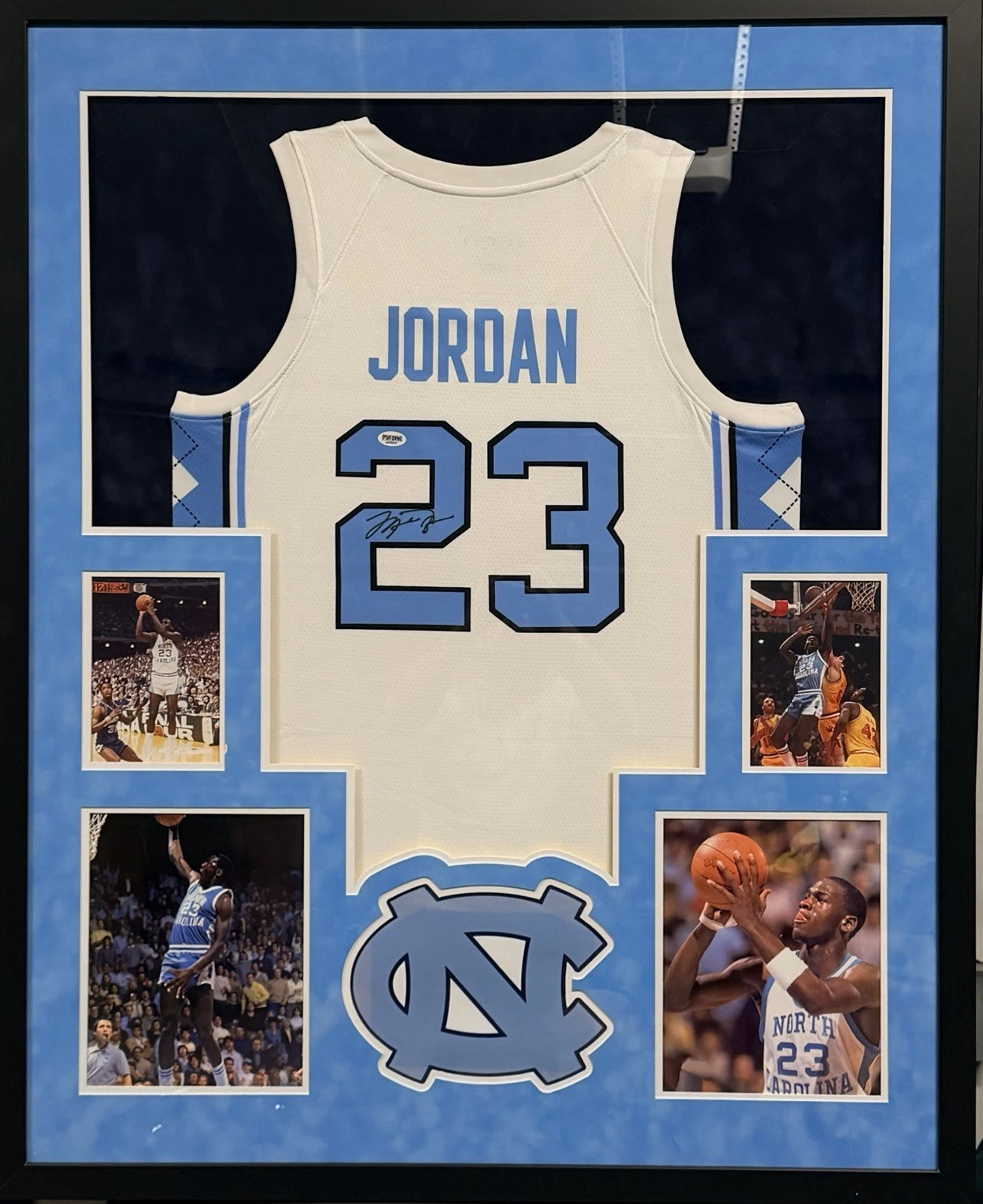 Framed Michael Jordan North Carolina number 23 jersey on the shelf back wall